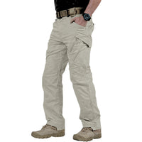 Thumbnail for A person wearing light khaki tactical cargo pants, paired with a black shirt, brown belt, and tan combat boots, shown from the waist down on a white background.
