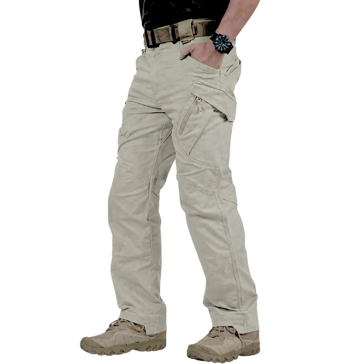 A person wearing light khaki tactical cargo pants, paired with a black shirt, brown belt, and tan combat boots, shown from the waist down on a white background.