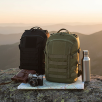 Thumbnail for Two curve tactical daypacks, one black and one olive green, displayed on a rocky peak with a sunset background. The green backpack is styled with a brown leather camera case, a vintage camera, and a stainless steel water bottle on a map, while the black backpack stands beside it.